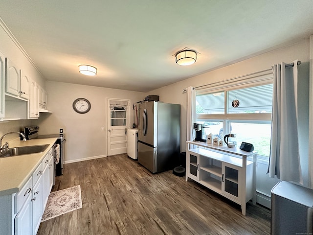 11 Polk Ln, Windsor Locks, CT 06096 - kitchen with stainless steel appliances, white cabinets, dark wood-type flooring, light countertops, and a baseboard heating unit