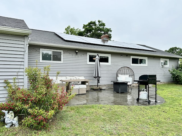 11 Polk Ln, Windsor Locks, CT 06096 - rear view of property with a yard, a patio area, solar panels, a chimney, and a shingled roof