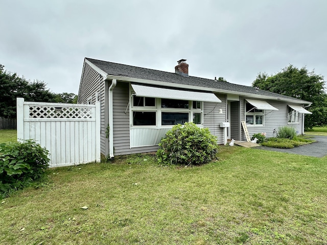 11 Polk Ln, Windsor Locks, CT 06096 - bungalow-style house featuring a chimney and a front lawn