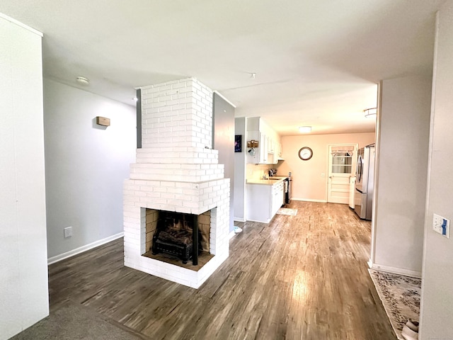 11 Polk Ln, Windsor Locks, CT 06096 - unfurnished living room with light wood finished floors and a brick fireplace