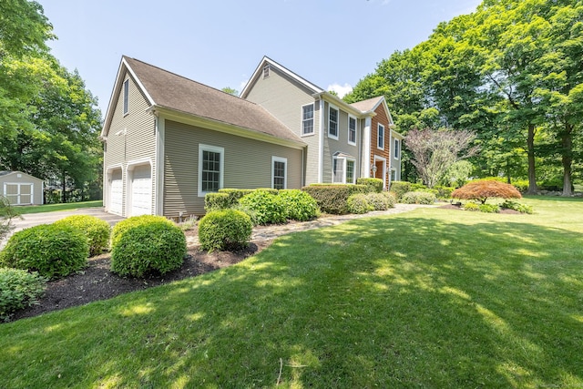 427 Long Mountain Rd, New Milford, CT 06776 - view of front of home with a front lawn, a storage shed, a garage, and driveway