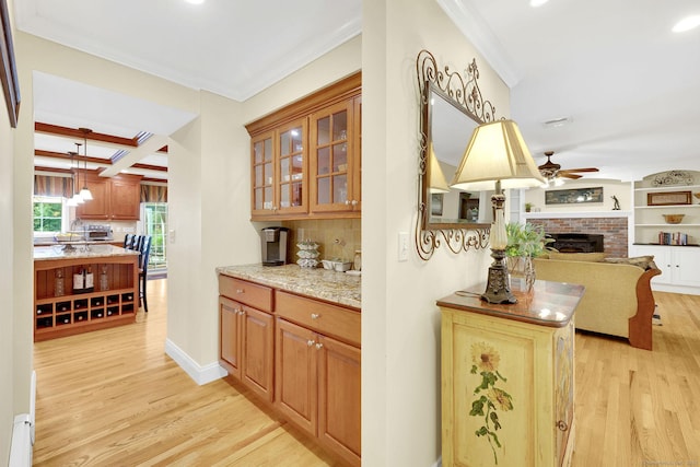 427 Long Mountain Rd, New Milford, CT 06776 - bar with light wood-type flooring, a ceiling fan, ornamental molding, a brick fireplace, and backsplash