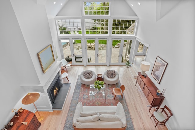 21 Oak Ridge Park, Westport, CT 06880 - living room with a towering ceiling, wood finished floors, french doors, and a warm lit fireplace