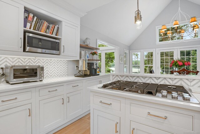 21 Oak Ridge Park, Westport, CT 06880 - kitchen with appliances with stainless steel finishes, open shelves, decorative backsplash, light countertops, and white cabinetry