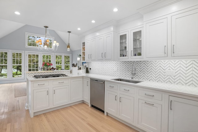 21 Oak Ridge Park, Westport, CT 06880 - kitchen with stainless steel appliances, light countertops, white cabinetry, light wood-style floors, and a peninsula