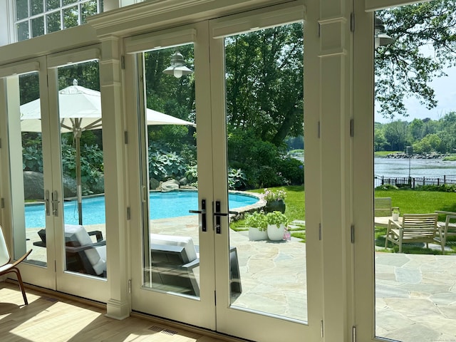 21 Oak Ridge Park, Westport, CT 06880 - doorway to outside with french doors, a water view, and wood finished floors