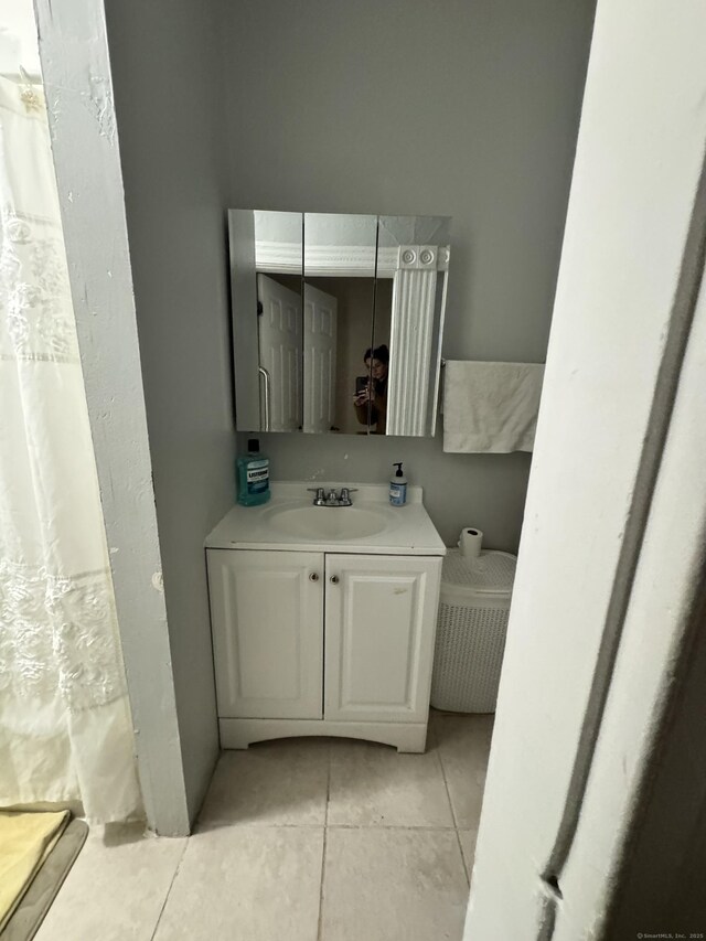 203 S Leonard St, Waterbury, CT 06708 - full bathroom with tile patterned floors, vanity, and a shower with shower curtain