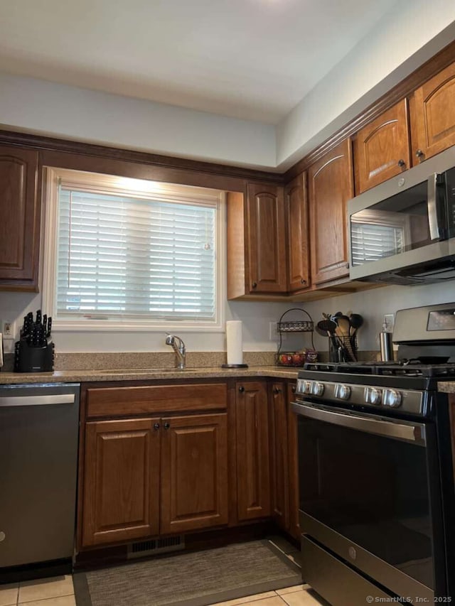 330 Crystal Ave Unit 20, New London, CT 06320 - kitchen with stainless steel appliances, light tile patterned floors, and dark stone counters