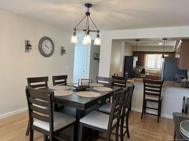 330 Crystal Ave Unit 20, New London, CT 06320 - dining space with light wood-style flooring and baseboards