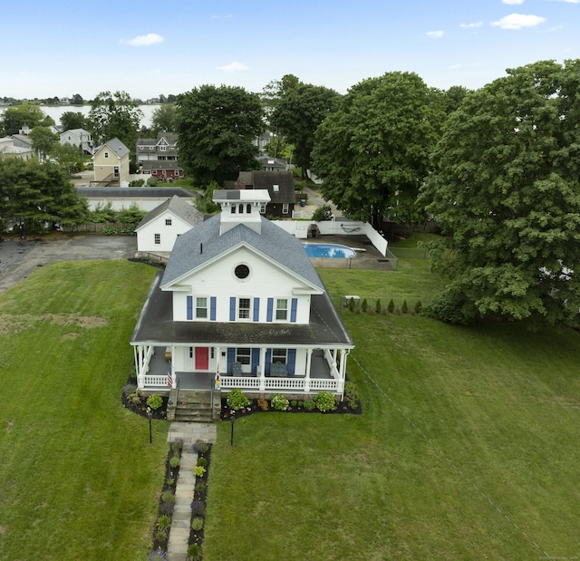 122 College St, Old Saybrook, CT 06475 - view of front facade with a porch, a front lawn, roof with shingles, and an outdoor pool