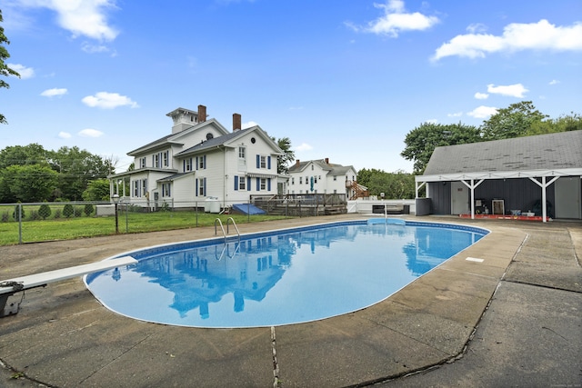 122 College St, Old Saybrook, CT 06475 - view of swimming pool featuring a diving board, a deck, and a patio