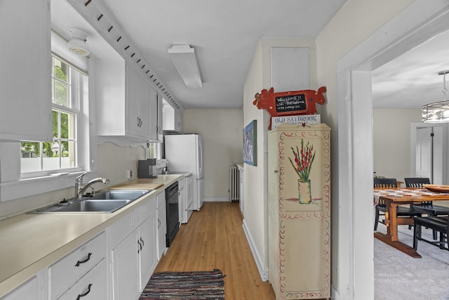 122 College St, Old Saybrook, CT 06475 - kitchen featuring dishwasher, white cabinets, light countertops, freestanding refrigerator, and radiator heating unit