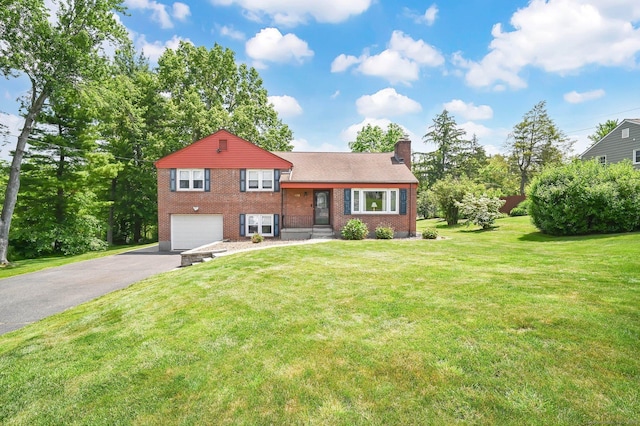 133 Savage Hill Rd, Berlin, CT 06037 - split level home featuring asphalt driveway, a chimney, an attached garage, brick siding, and a front lawn