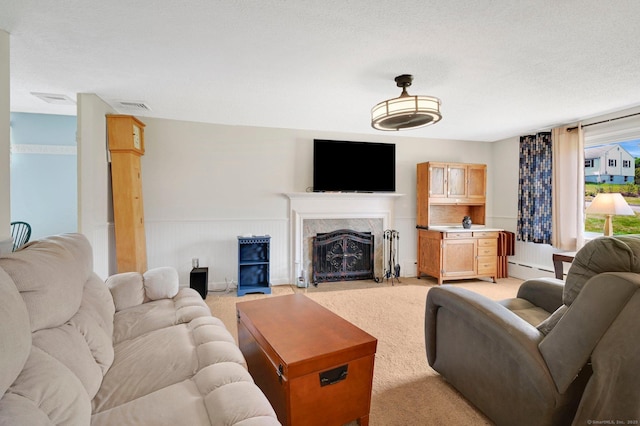 133 Savage Hill Rd, Berlin, CT 06037 - living room with a high end fireplace, light colored carpet, baseboard heating, wainscoting, and a textured ceiling