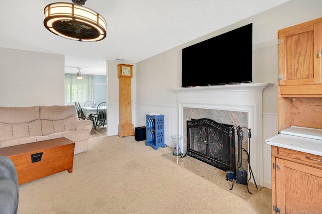 133 Savage Hill Rd, Berlin, CT 06037 - living room featuring light carpet, a fireplace, and a wainscoted wall