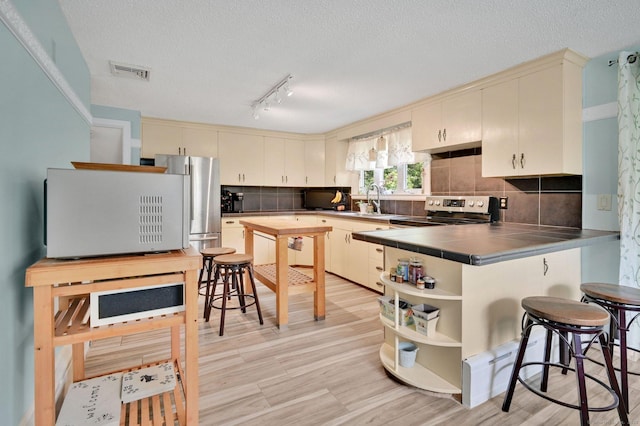 133 Savage Hill Rd, Berlin, CT 06037 - kitchen with tile countertops, stainless steel appliances, open shelves, backsplash, and a breakfast bar area