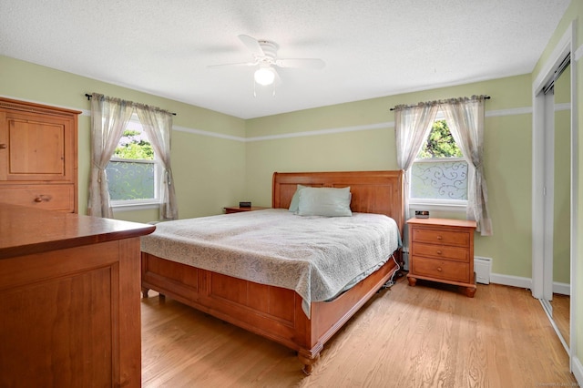 133 Savage Hill Rd, Berlin, CT 06037 - bedroom featuring light wood-style flooring, baseboard heating, and ceiling fan