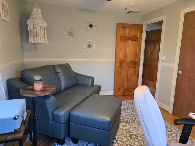 133 Savage Hill Rd, Berlin, CT 06037 - living area with wood finished floors and a textured ceiling
