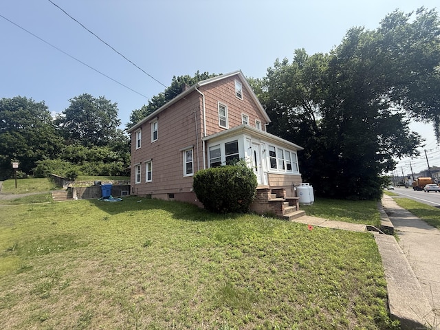 384 Park St, Bristol, CT 06010 - view of side of home featuring a yard and entry steps