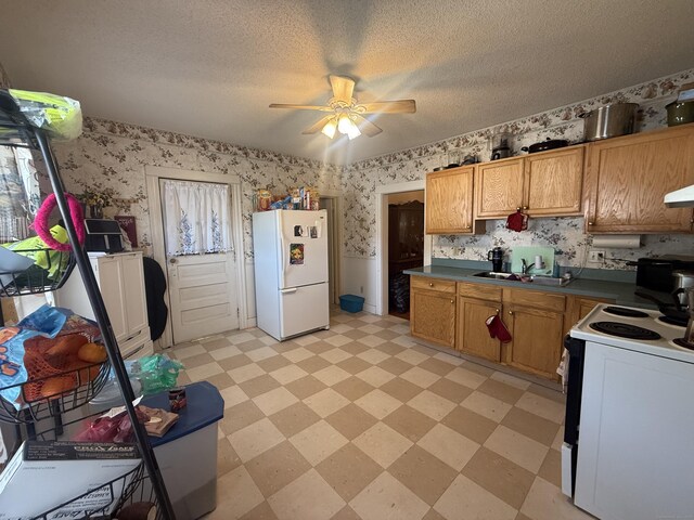 384 Park St, Bristol, CT 06010 - kitchen featuring white appliances, wallpapered walls, light floors, a ceiling fan, and dark countertops