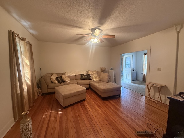 384 Park St, Bristol, CT 06010 - living room with hardwood / wood-style flooring, a ceiling fan, a textured ceiling, and radiator heating unit