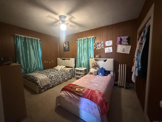 384 Park St, Bristol, CT 06010 - bedroom with carpet floors, radiator heating unit, ceiling fan, and wood walls