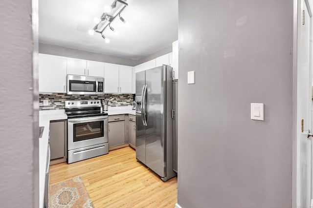 15 Perry Ave Unit D1, Norwalk, CT 06850 - kitchen with stainless steel appliances, backsplash, light wood finished floors, and white cabinets