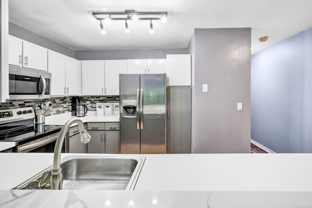 15 Perry Ave Unit D1, Norwalk, CT 06850 - kitchen with stainless steel appliances, decorative backsplash, light countertops, and white cabinetry