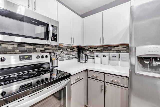 15 Perry Ave Unit D1, Norwalk, CT 06850 - kitchen with stainless steel appliances, light countertops, tasteful backsplash, and white cabinetry