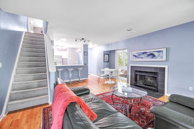 15 Perry Ave Unit D1, Norwalk, CT 06850 - living room with stairway, wood finished floors, a fireplace, and rail lighting