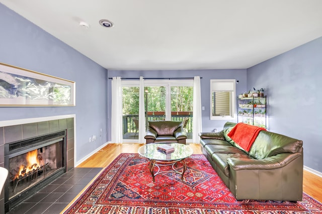 15 Perry Ave Unit D1, Norwalk, CT 06850 - living area featuring a tiled fireplace and wood finished floors