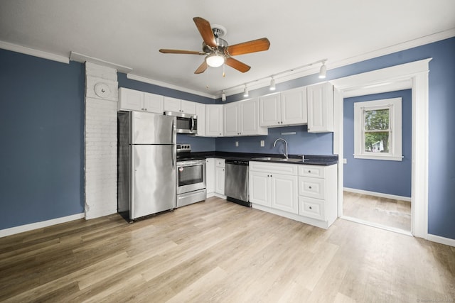 692 Enfield St, Enfield, CT 06082 - kitchen with stainless steel appliances, dark countertops, a ceiling fan, rail lighting, and light wood-style flooring
