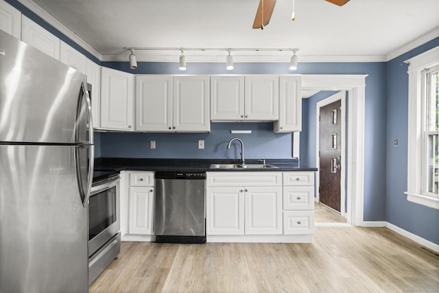 692 Enfield St, Enfield, CT 06082 - kitchen featuring appliances with stainless steel finishes, dark countertops, white cabinets, and light wood-style flooring