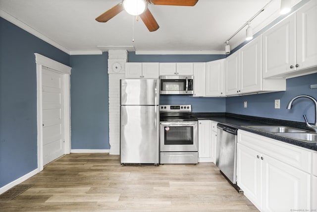 692 Enfield St, Enfield, CT 06082 - kitchen with stainless steel appliances, ornamental molding, a ceiling fan, dark countertops, and white cabinets