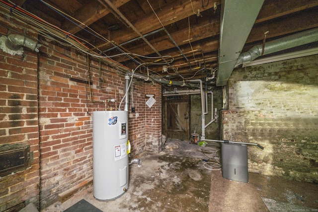 692 Enfield St, Enfield, CT 06082 - unfinished below grade area featuring electric water heater and brick wall