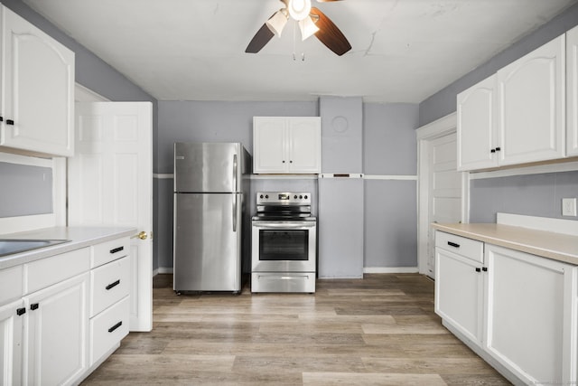 692 Enfield St, Enfield, CT 06082 - kitchen featuring stainless steel appliances, ceiling fan, light countertops, white cabinets, and light wood finished floors