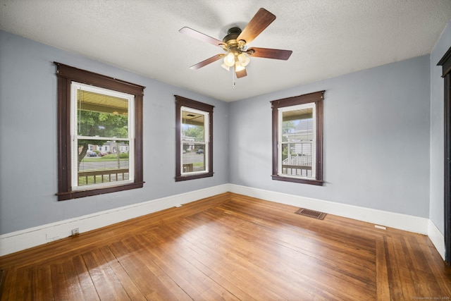 692 Enfield St, Enfield, CT 06082 - spare room featuring plenty of natural light, ceiling fan, wood-type flooring, and a textured ceiling