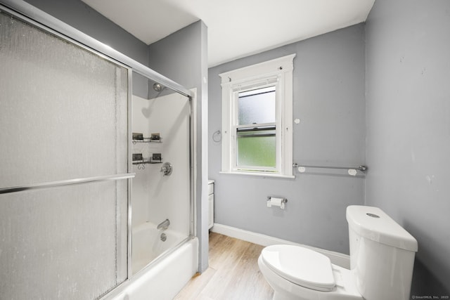 692 Enfield St, Enfield, CT 06082 - bathroom featuring wood finished floors and shower / bath combination with glass door
