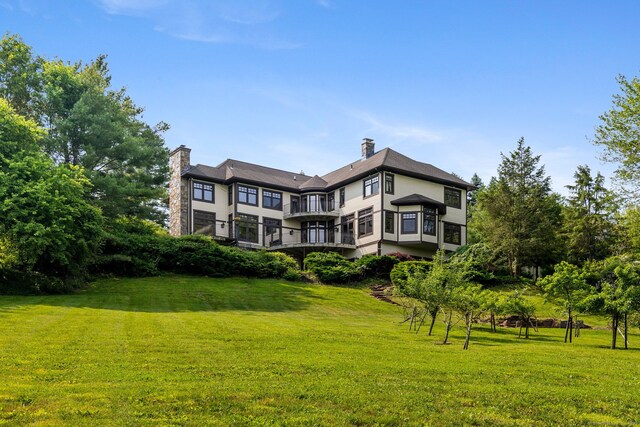 9 Cobtail Way, Simsbury, CT 06070 - rear view of house featuring a lawn, a balcony, and a chimney