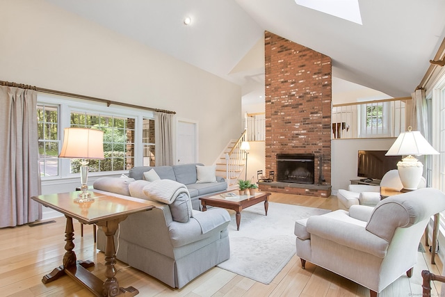 39 Wampum Hill Rd, Weston, CT 06883 - living area with high vaulted ceiling, stairway, healthy amount of natural light, and light wood-style flooring