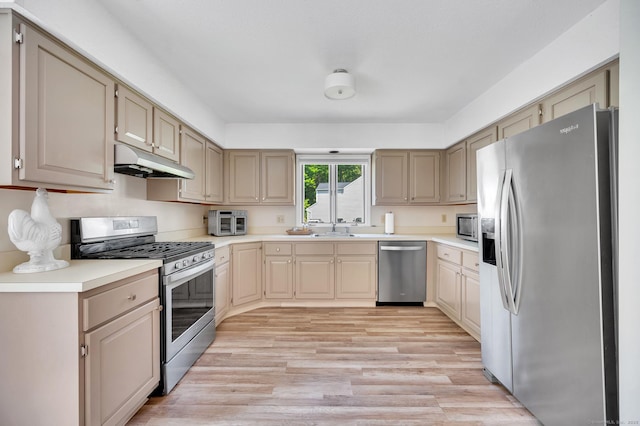 80 Quarry Village Rd, Cheshire, CT 06410 - kitchen with stainless steel appliances, under cabinet range hood, light wood-style floors, and light countertops