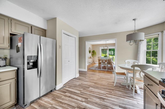 80 Quarry Village Rd, Cheshire, CT 06410 - kitchen with stainless steel fridge, healthy amount of natural light, light wood-style flooring, a textured ceiling, and decorative light fixtures
