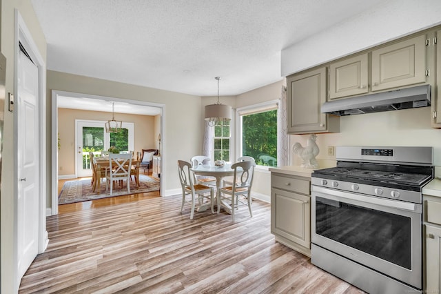 80 Quarry Village Rd, Cheshire, CT 06410 - kitchen with under cabinet range hood, stainless steel range with gas cooktop, light wood finished floors, healthy amount of natural light, and a textured ceiling