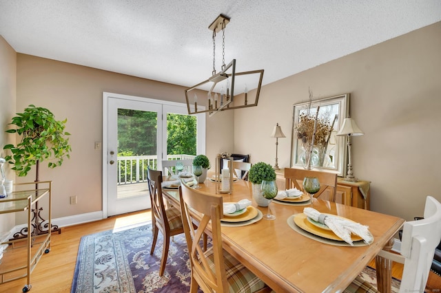 80 Quarry Village Rd, Cheshire, CT 06410 - dining room with healthy amount of natural light, a chandelier, a textured ceiling, and light wood finished floors