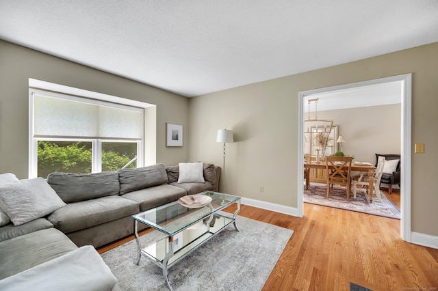 80 Quarry Village Rd, Cheshire, CT 06410 - living room featuring light wood-style floors and a chandelier