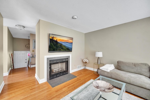80 Quarry Village Rd, Cheshire, CT 06410 - living area featuring wood finished floors and a fireplace with flush hearth