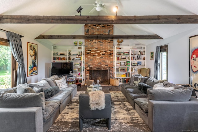 living area with a ceiling fan, plenty of natural light, a fireplace, and wood finished floors