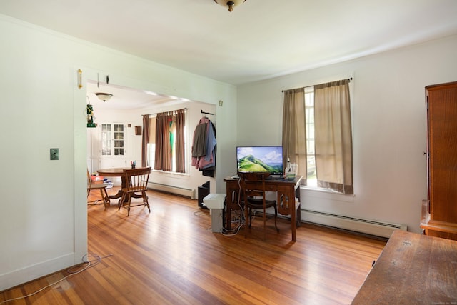 182 Church St, North Canaan, CT 06018 - living area featuring a baseboard heating unit, wood finished floors, a baseboard radiator, and crown molding