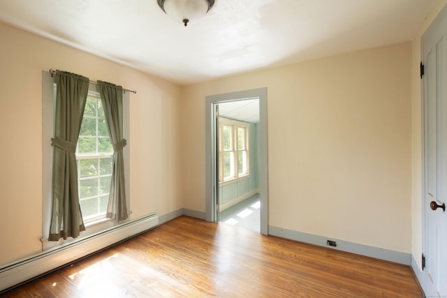 182 Church St, North Canaan, CT 06018 - empty room featuring a baseboard radiator, plenty of natural light, and wood finished floors