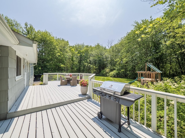 1 Blue Ridge Ln, Wilton, CT 06897 - wooden deck with a playground, grilling area, and a view of trees